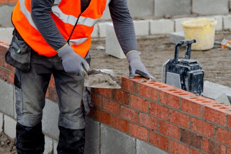 Highland Masonry worker laying bricks